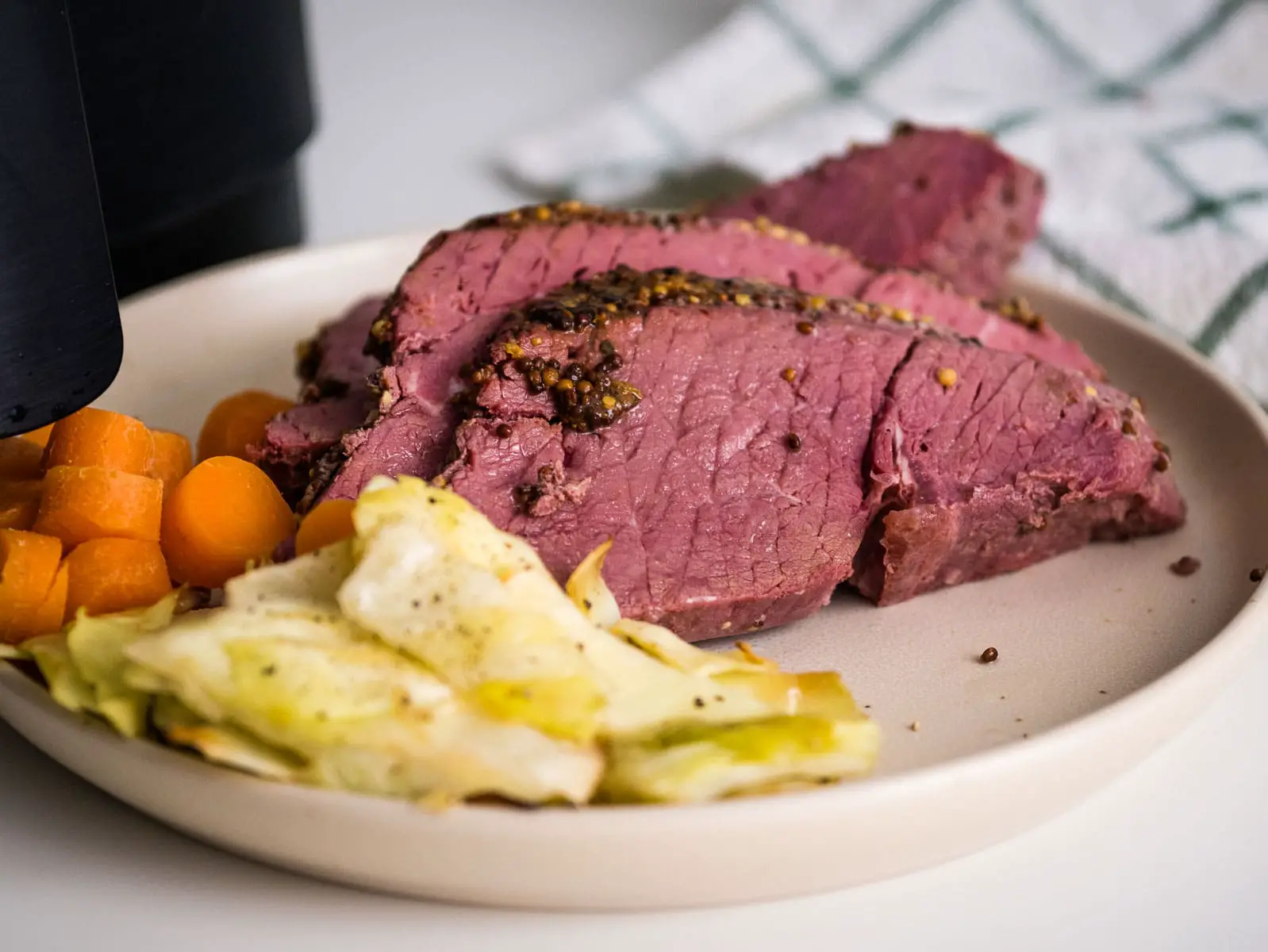 Should you cut corned beef with or against the grain?