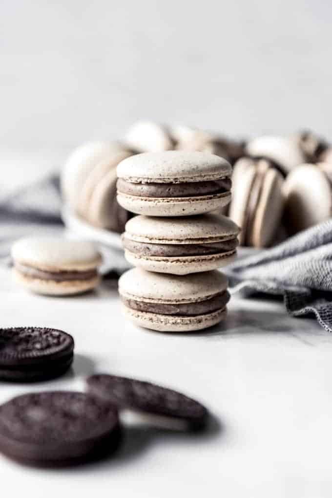 A stack of three cookies and cream macarons.