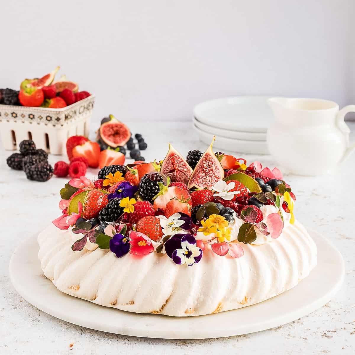 Angled view of pavlova topped with fruit