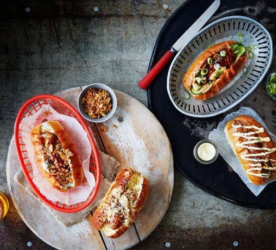 Topped hot dogs on a plate