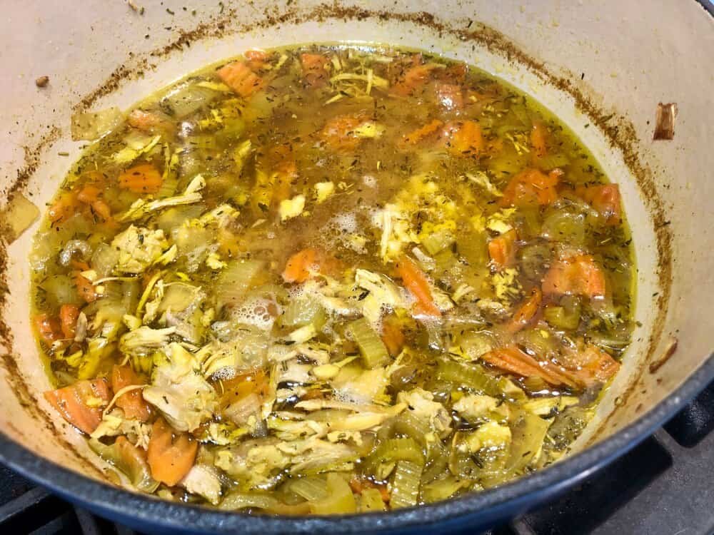 Homemade chicken soup with ginger in a pot