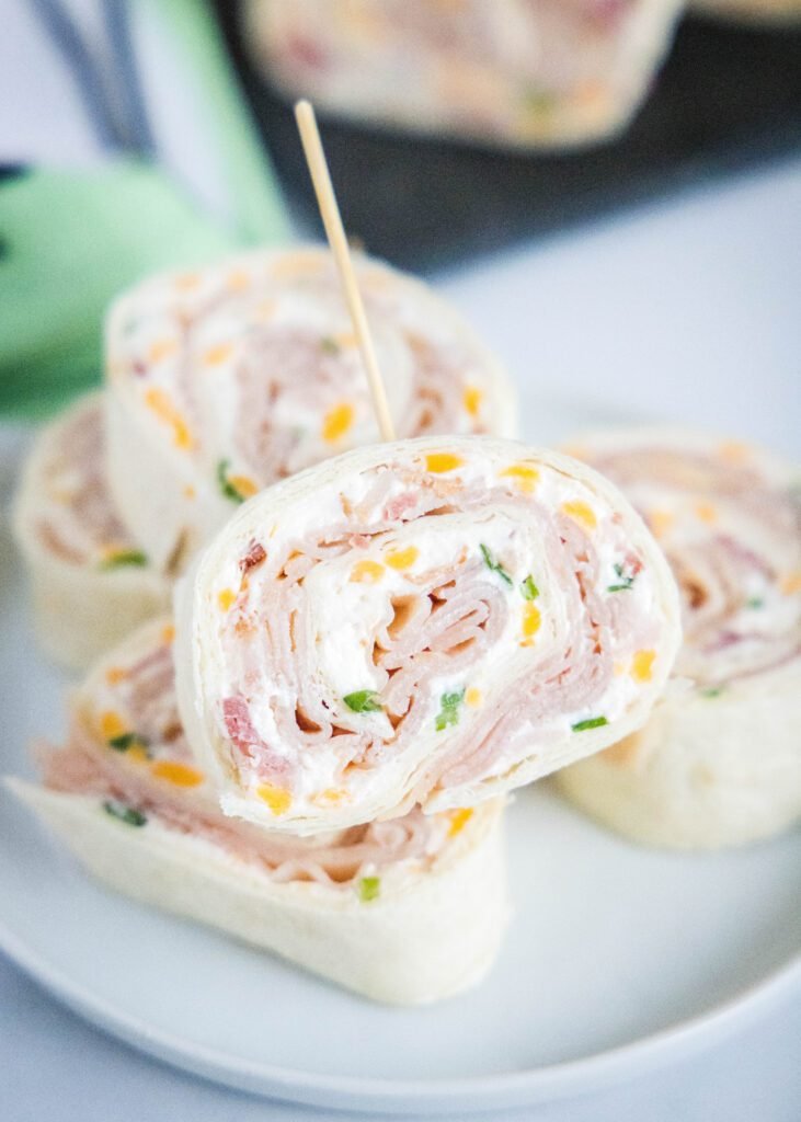 pinwheel sandwiches arranged on a white plate