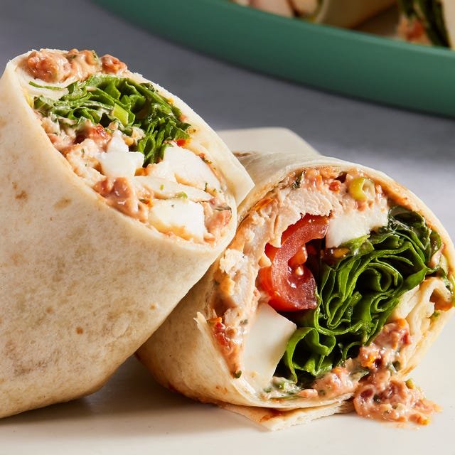 whole wheat wrap spread with parmesan herb mayonnaise and wrapped around chopped rotisserie chicken, creamy fresh mozzarella, spinach, and cherry tomatoes