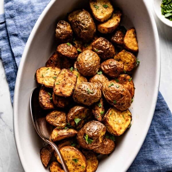 Air fried red potatoes on an oval plate from the top view.