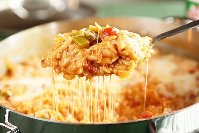 Spoonful of Cheesy Shrimp and Orzo Skillet with cheese pull