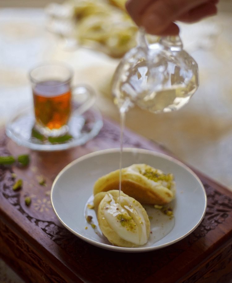 Atayef filled with Cream and drizzled with simple syrup.