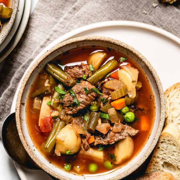 A Bowl of CrockPot Vegetable Beef Soup Recipe served with crusty bread