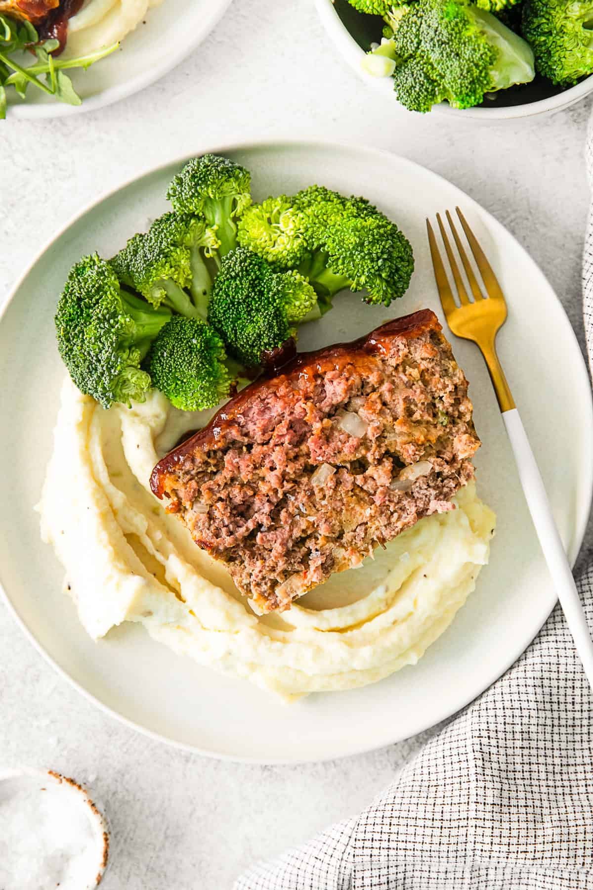BBQ Glazed Meatloaf on a plate with broccoli.