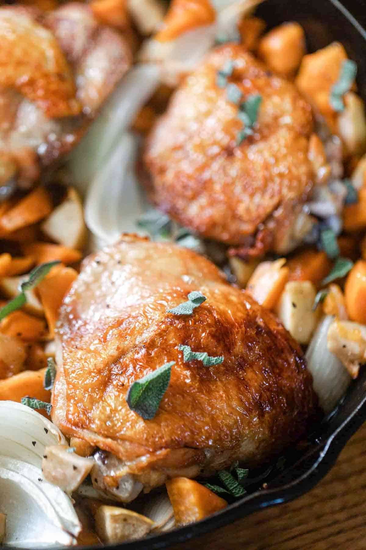 crispy maple roasted chicken with sweet potatoes and apples.