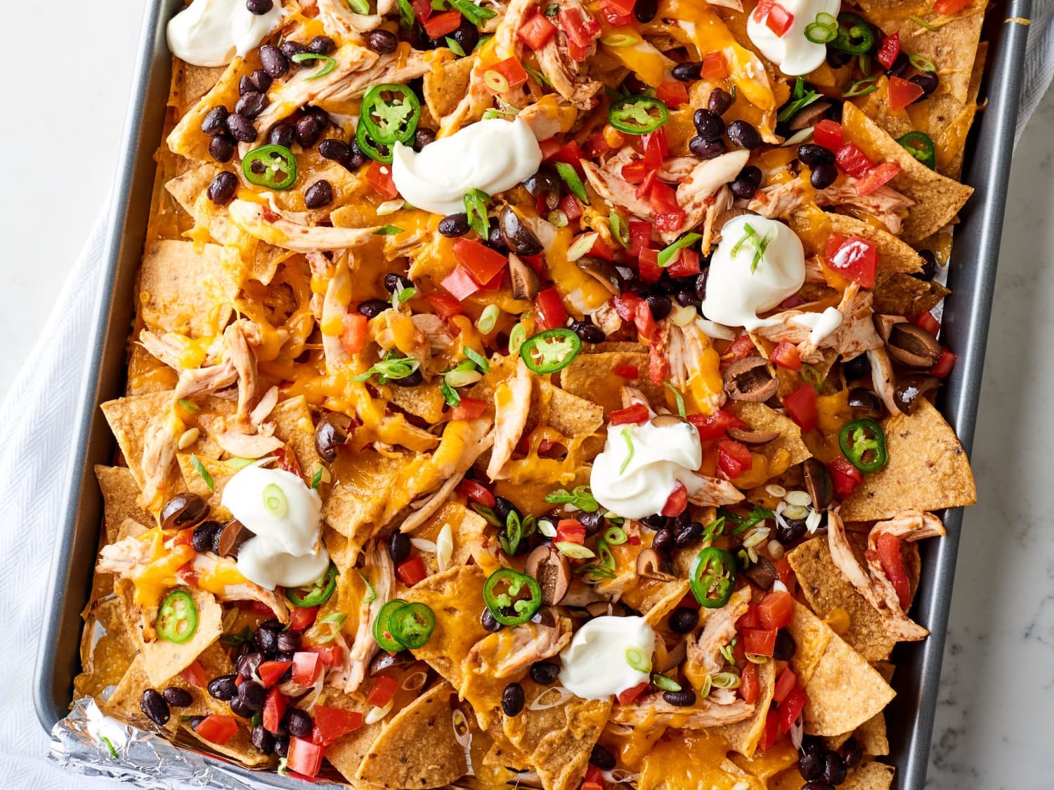 These Easy Sheet Pan Chicken Nachos Will Make You a Dinner Hero
