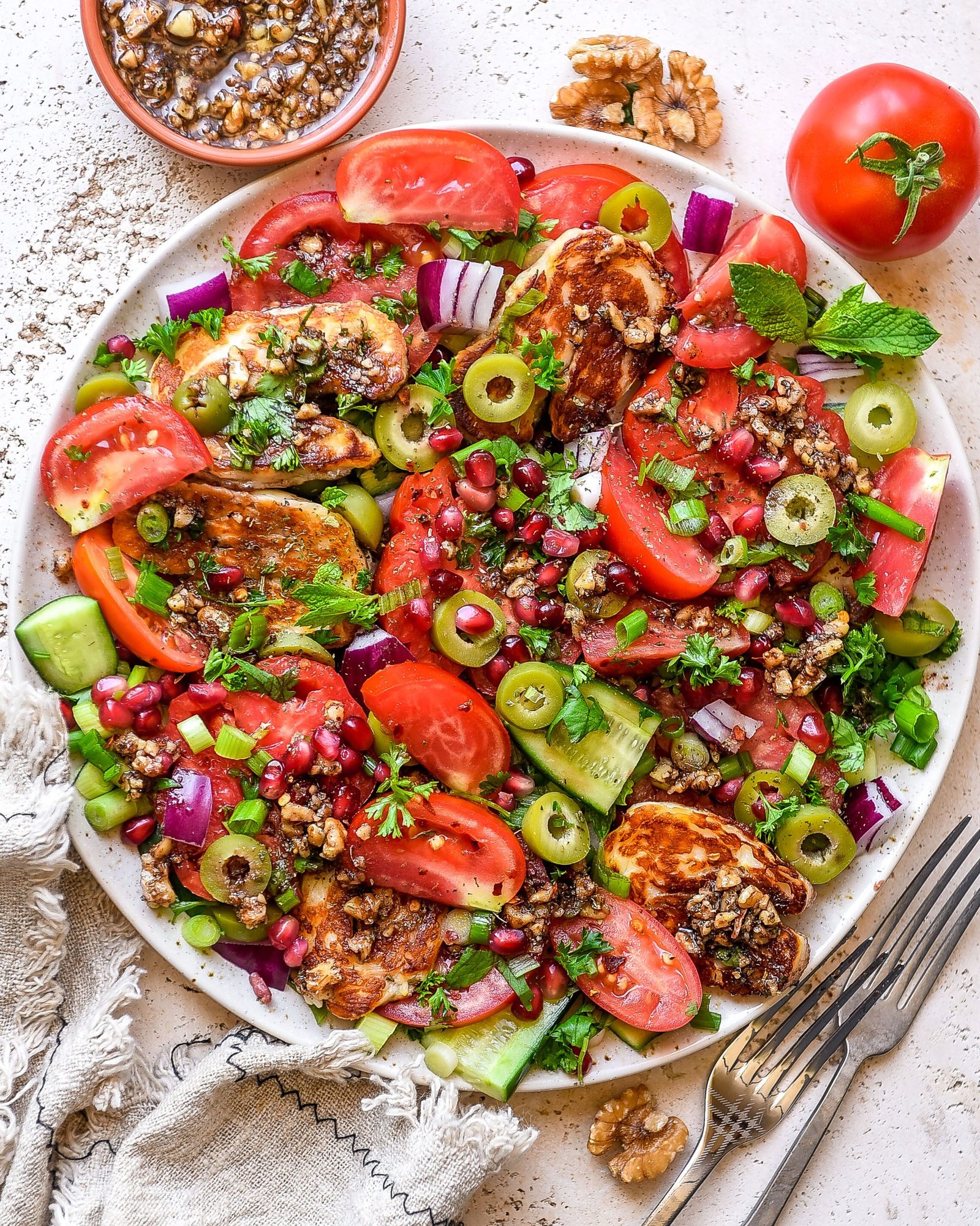 Tomato Halloumi Salad with Pomegranate Walnut Dressing | Nourish Deliciously